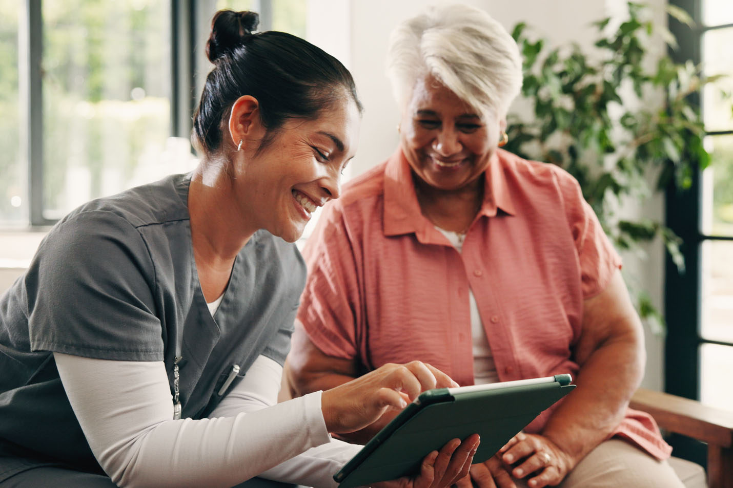 A nurse talking with someone at an assisted living facility